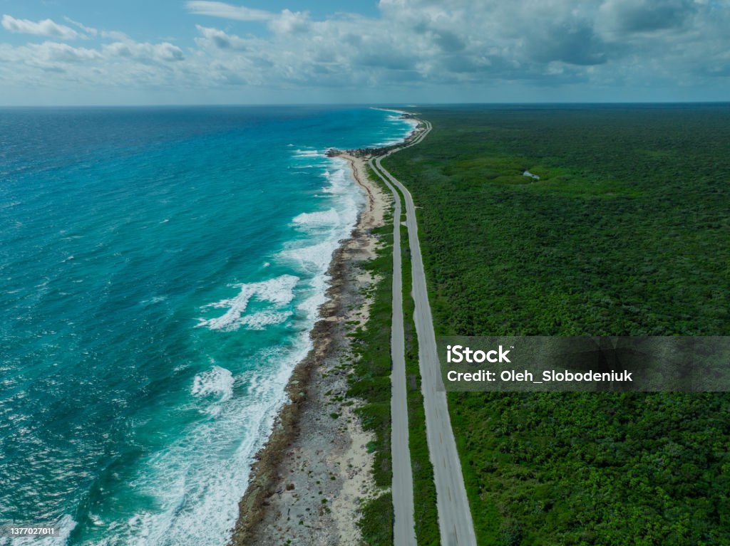 Aerial view of road on  Cozumel Island near Playa del Carmen at sunset Scenic aerial  view of road on  Cozumel Island near Playa del Carmen at sunset, Quintana Roo, Mexico Road Stock Photo