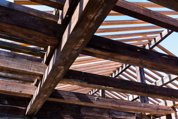 Closeup old damaged and rusty corrugated iron roof with chimney, white background with copy space, full frame horizontal composition