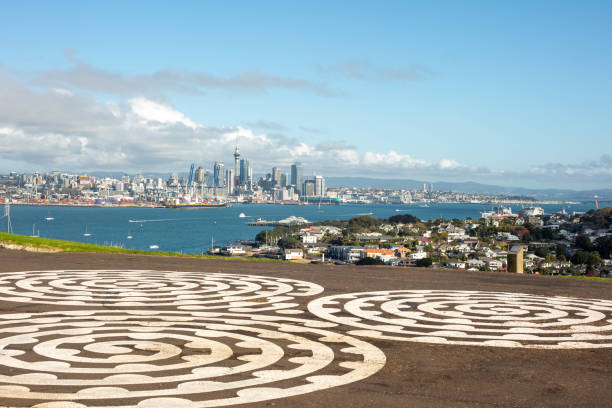 Auckland city line as seen from Devonport, North Head historic reserve. Auckland city line as seen from Devonport, North Head historic reserve. Sunny day. White circular paintings on the street in the foreground. Waitemata Harbor stock pictures, royalty-free photos & images