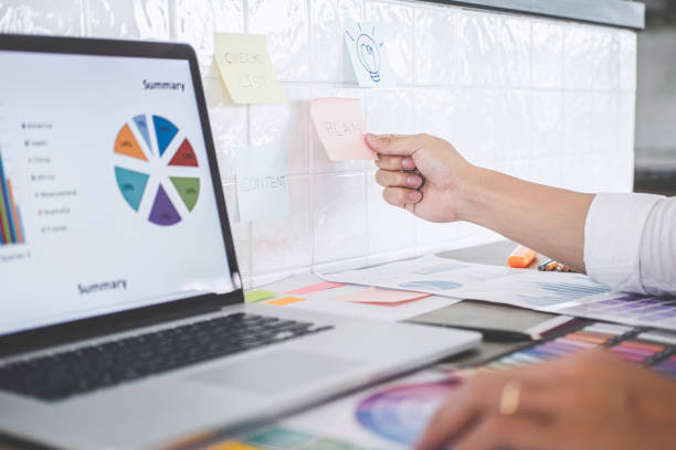 istock Young creative graphic designer working on project architectural drawing and color swatches, selection coloring on graphic chart with work tools and equipment 1377086723