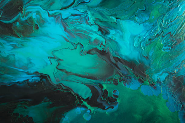istock Fluid Art. Metallic Green and blue abstract wave swirls on black background. Marble effect background or texture 1377091403