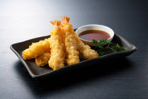 istock Shrimp tempura on a plate placed against a black background. 1377103600