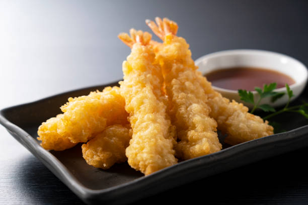 istock Shrimp tempura on a plate placed against a black background. 1377103601