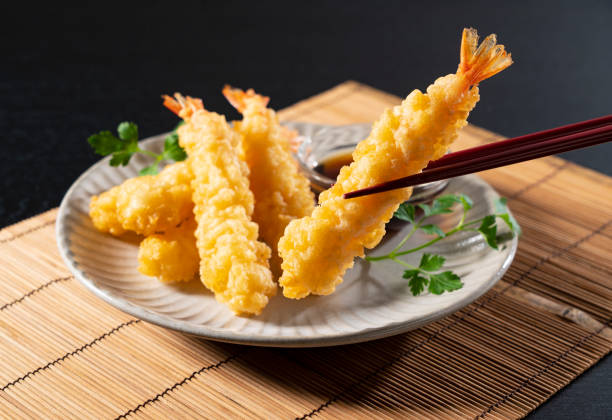 istock Shrimp tempura on a plate placed against a black background. 1377103628