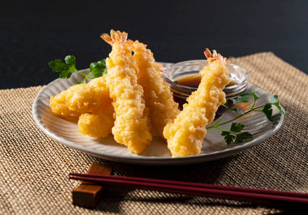 istock Shrimp tempura on a plate placed against a black background. 1377103638