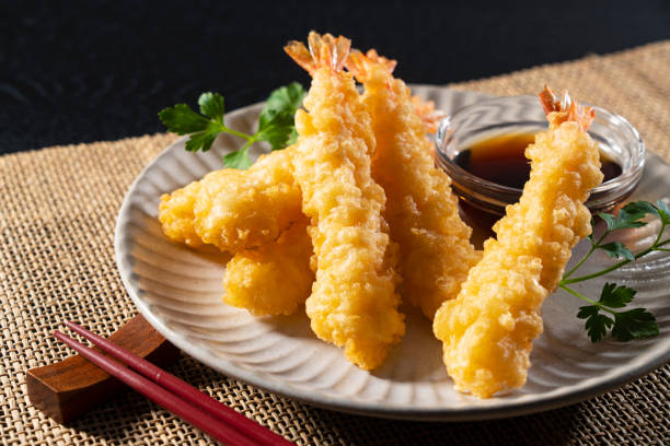 istock Shrimp tempura on a plate placed against a black background. 1377103642