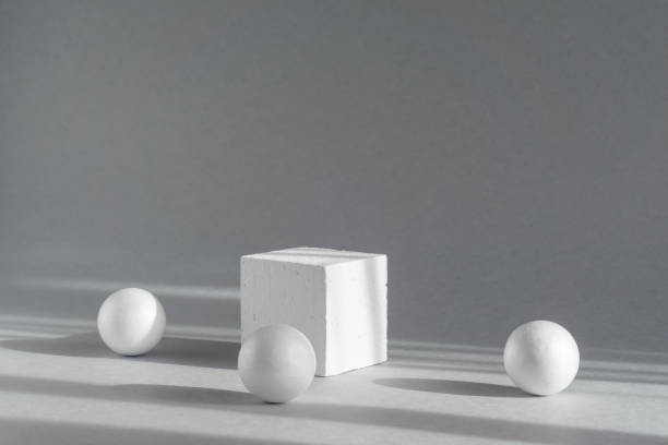 istock Geometric white square podium pedestal surrounded by spheres. Abstract 3d composition on gray background, in rays of sunlight. Concept of presentation of packaging for cosmetics 1377103710