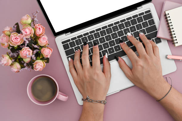 istock Young woman using laptop computer on pink background. 1377156785