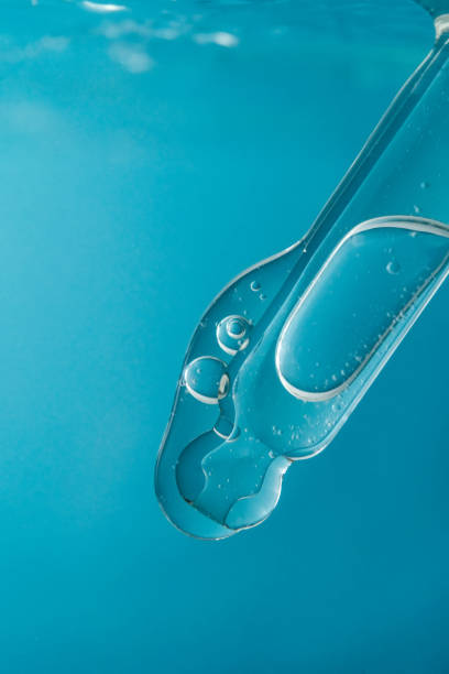 istock Pipette with cosmetic product in water with bubbles. 1377176164