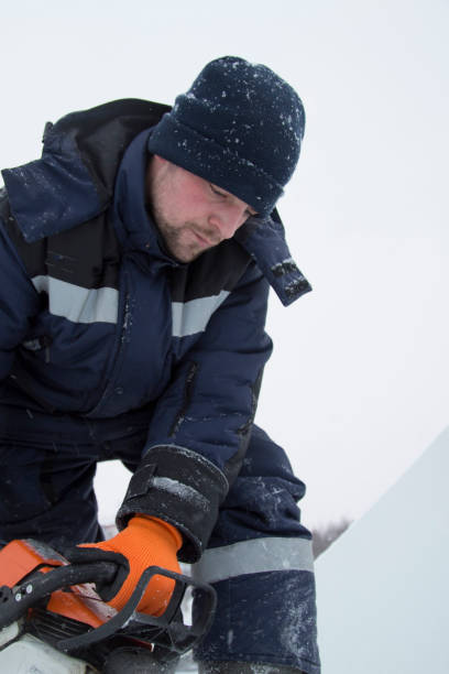 istock Worker cuts a lump of ice with a chainsaw 1377187197