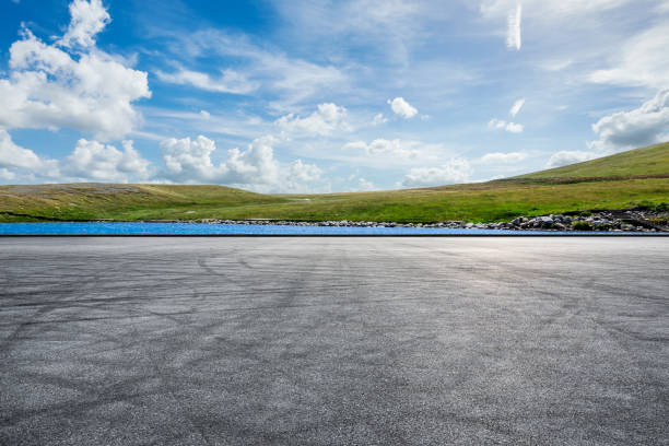 istock Asphalt road and lake with green grass 1377201397