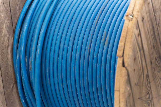 istock New blue power cable is wound on wooden coil. Background 1377212634