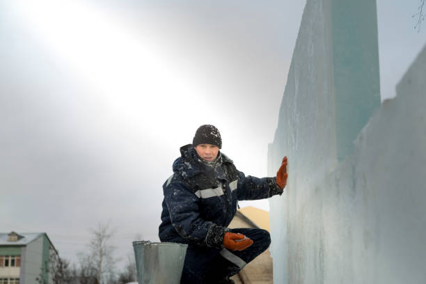 istock Worker covers the joints of ice panels with wet snow 1377223313