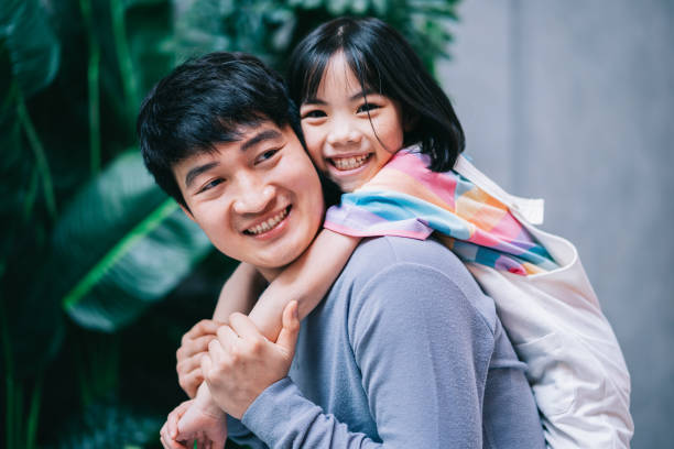 Asian father and daughter at home