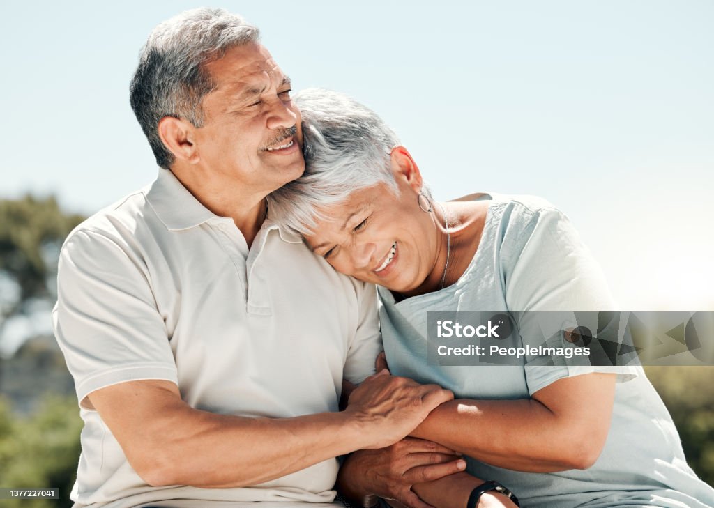 Shot of senior couple spending time together in nature He makes me smile like no other Senior Adult Stock Photo