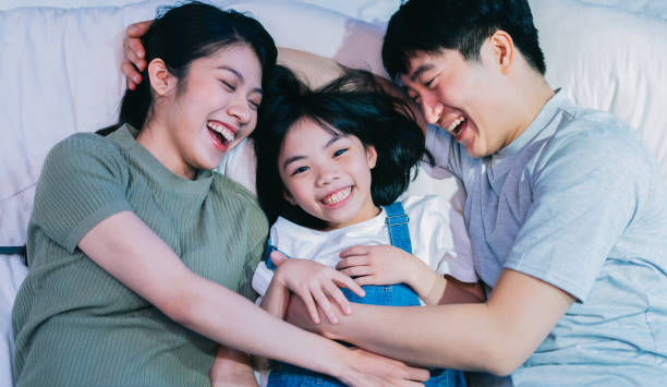istock Young Asian family on the bed 1377229753