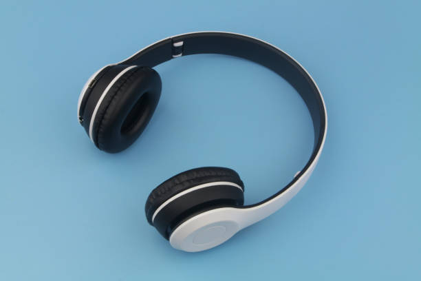 istock Wireless headphones on blue background 1377232427