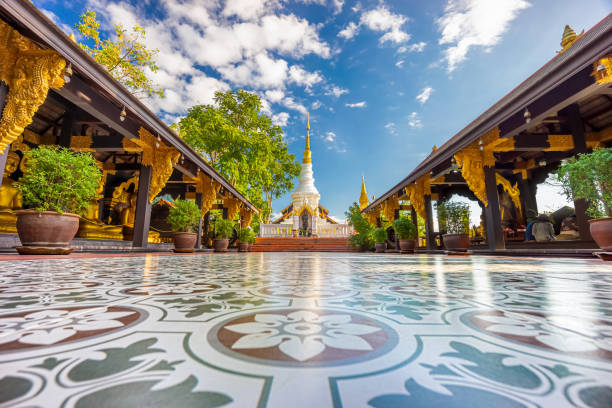 Beautiful white chedi with golden top behind two open-sided pavilions at Wat Phra That Doi Phra Chan