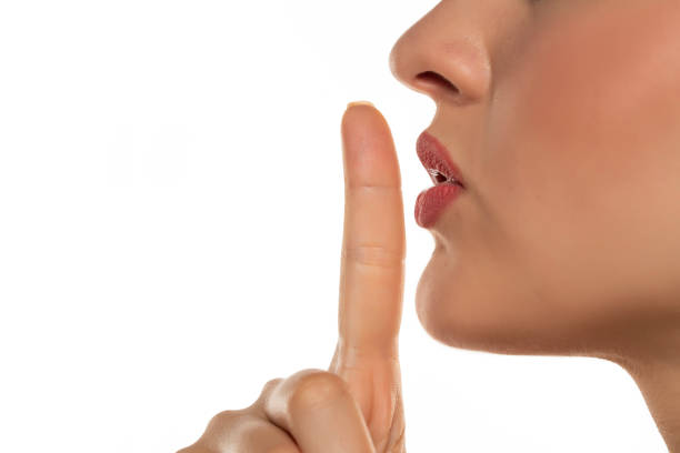 istock woman making a hush gesture 1377271959