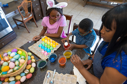 An African American family dying Easter eggs and celebrating Easter.