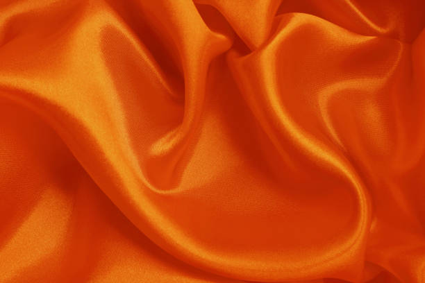 istock Orange fabric texture background, detail of silk or linen pattern. 1377300406