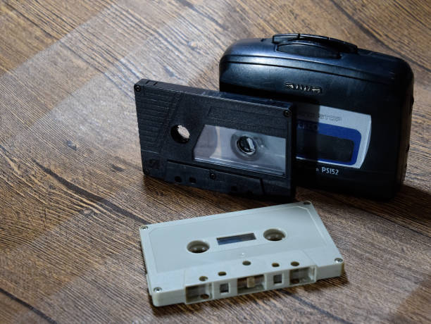 istock Retro audio cassettes next to a portable player to play compact cassettes. 1377301524