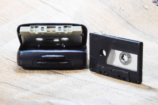 istock Retro audio cassettes next to a portable player to play compact cassettes. 1377301526