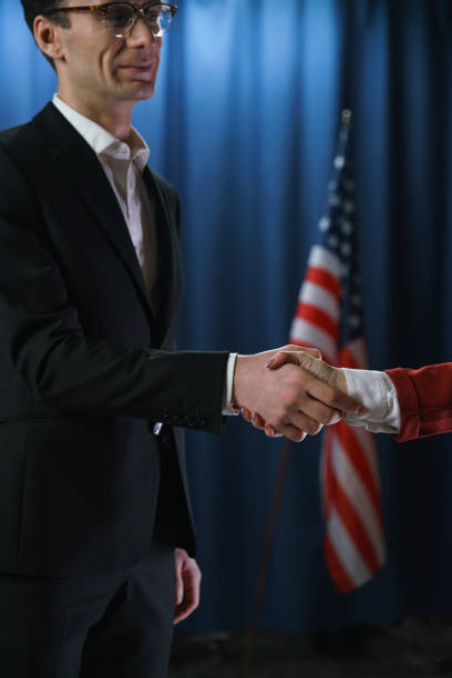 istock Politicians shaking hands after negotiations on a blue background 1377305297