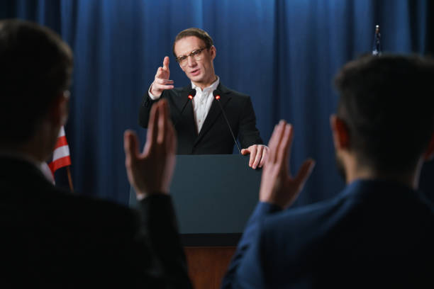istock Young speaker going to answer questions at the debates 1377314133