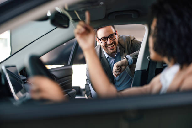 istock Smiling car salesman, checking if his customer is satisfied with 1377319880