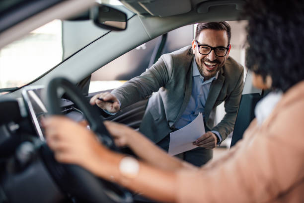 istock Helpful caucasian man, showing all the car specifications to his 1377319887