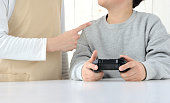 Mother scolding for child playing video game