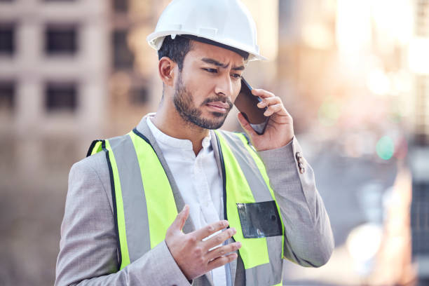 istock Cropped shot of a handsome male construction worker making a call while standing on a building site 1377331050