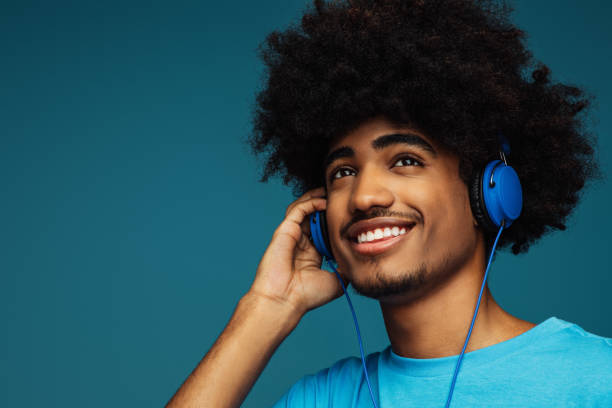 istock African american man with african hairstyle using phone 1377344836