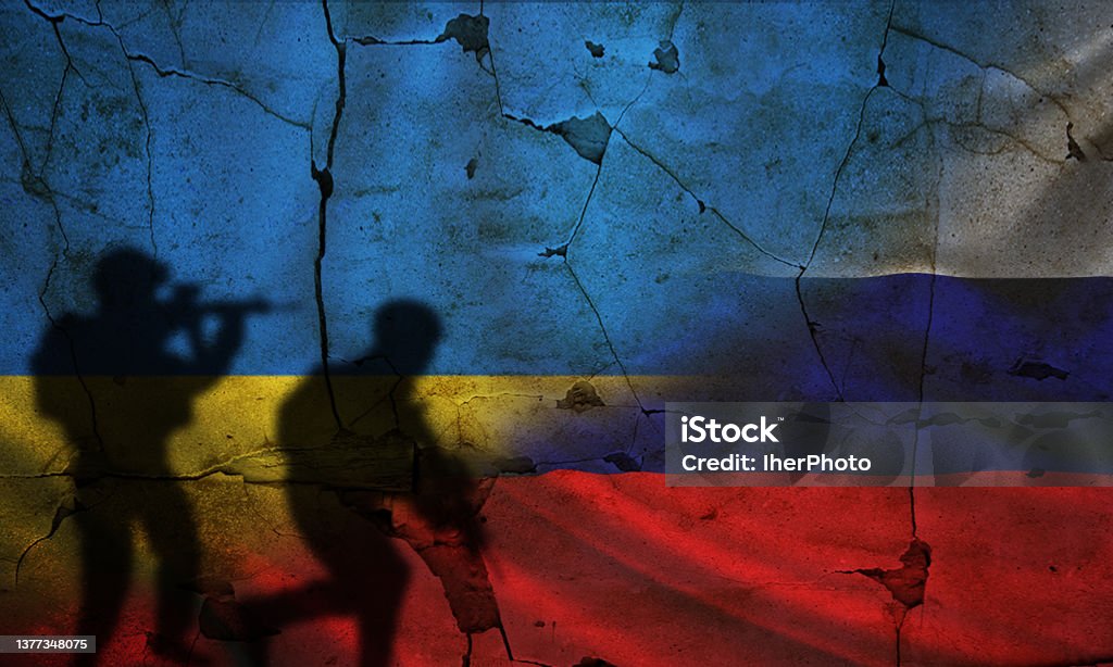 Russia vs Ukraine flag on cracked wall, concept of war between russia and ukraine, silhouette of soldiers on russia vs ukraine flag Ukraine Stock Photo
