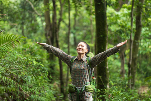 istock Freedom woman backpacker  hiking open arms in spring forest 1377350752