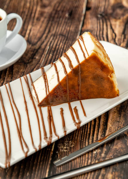 istock Sliced san sebastian cheesecake with coffee on wooden table 1377351437