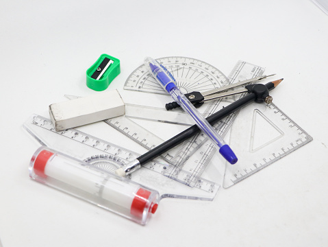 geometrical sketching tools like protractor, set square, ruler, pen, pencil, sharpener, compass and eraser isolated in a white background