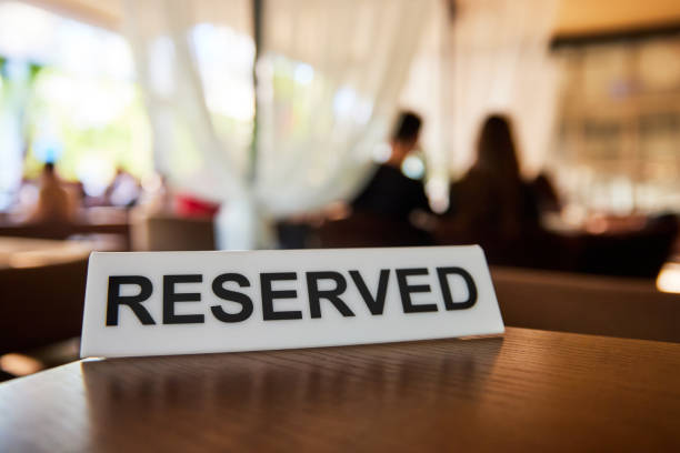 istock Plastic plaque with the inscription Reserved on the restaurant table. 1377365769
