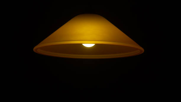 istock Yellow ceiling and lamp on a black background. 1377371712