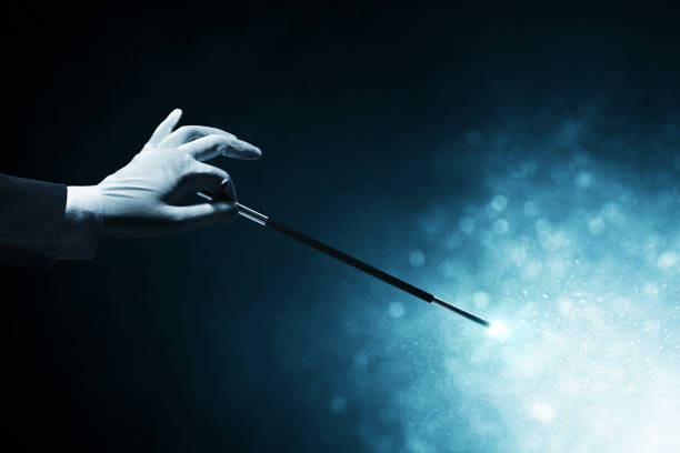 istock Magician hand holding magic wand 1377372752
