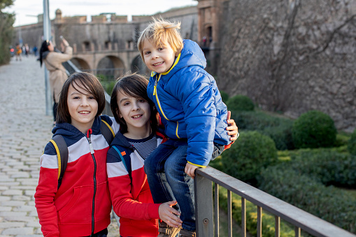 Cute little children tourists admiring Barcelona city, family travel with kids in Spain