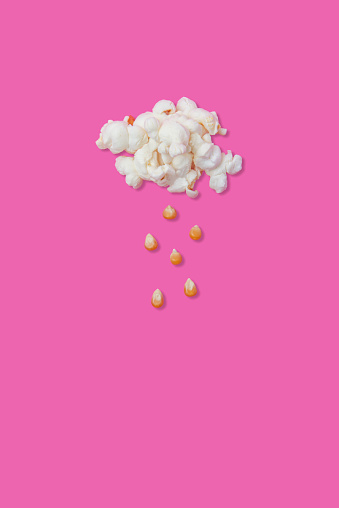Creative photos of popcorn on a pink background