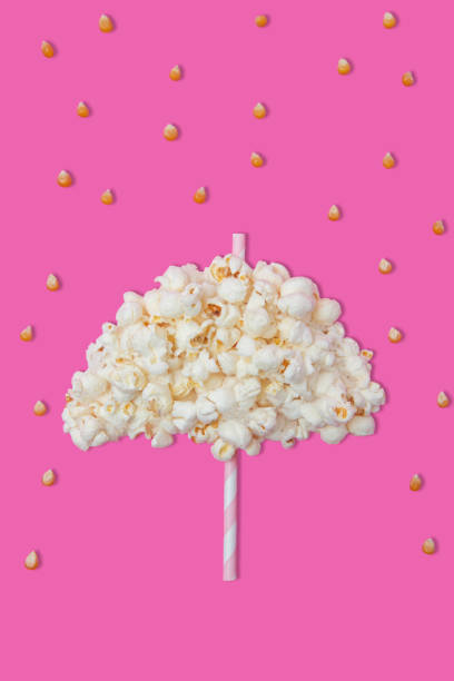 istock Creative photos of popcorn on a pink background 1377384862