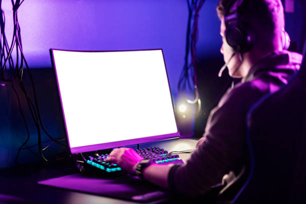 istock A focused gamer playing video games on computer in gaming room. 1377392486