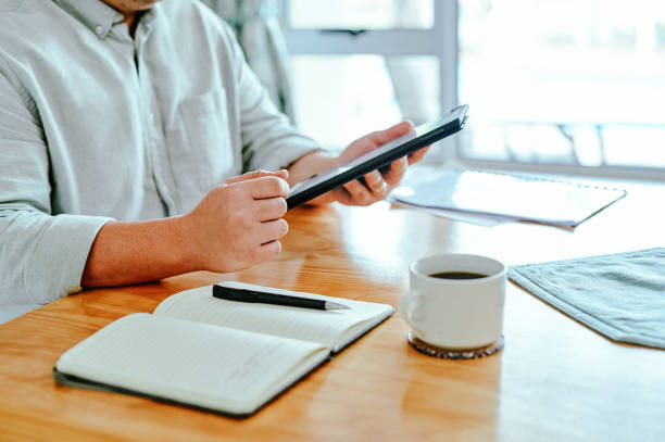istock Shot of a unrecognizable man using a tablet at home 1377403839