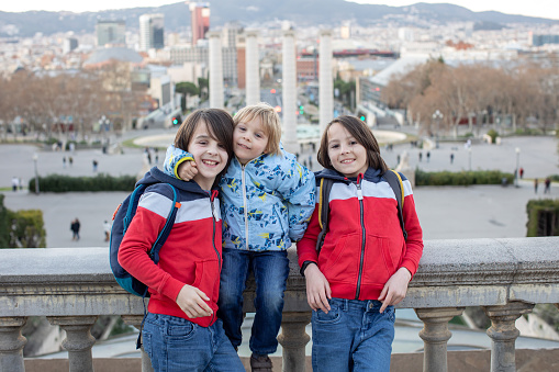 Family, standing in front of national museum in Barcelona, happy family holiday with children, Spain