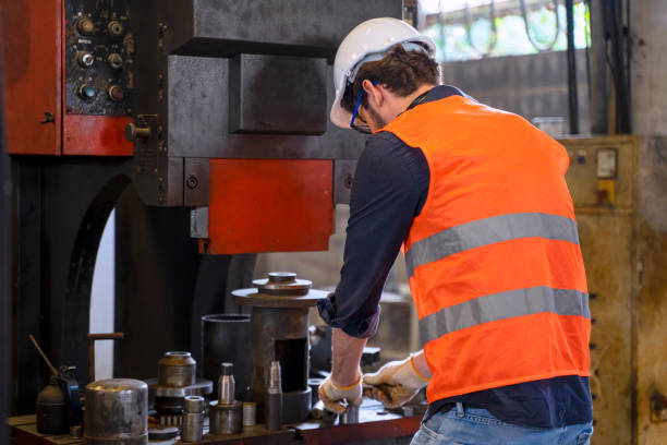 istock Blue collar worker with co worker at factory. 1377408815