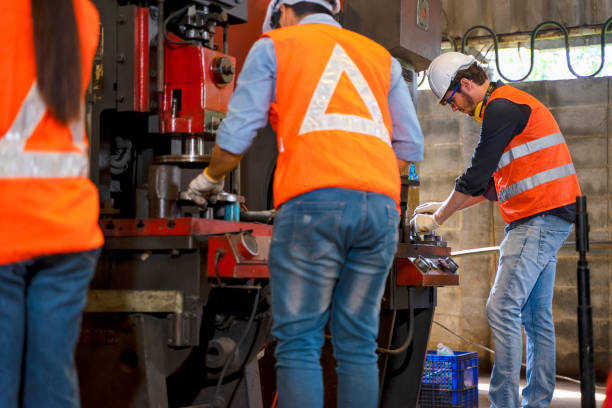 istock Blue collar worker with co worker at factory. 1377408833