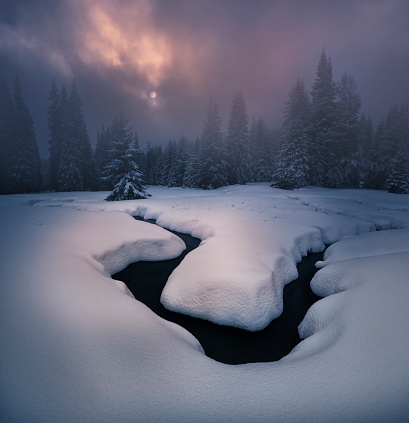 Small river and beautiful snow moment during sunset.